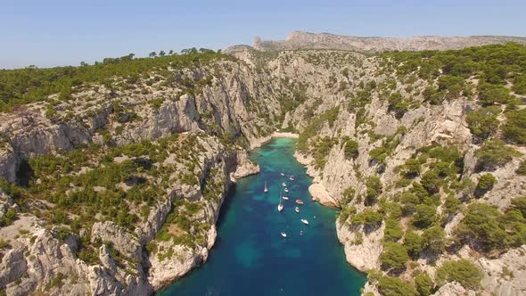 Aerial travel drone view of clear green water, cliffs of Cassis, Mediterranean Sea, Southern France. alt