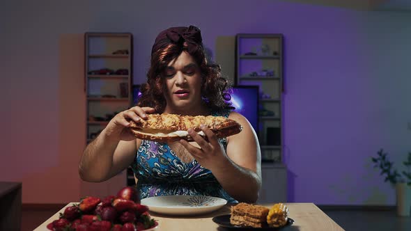 Man Dressed in Woman's Dress and Makeup on Face Eats a Huge Sandwich