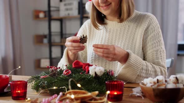 Happy Woman Making Fir Christmas Wreath at Home