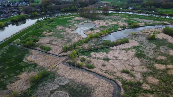 Overflowed Land on Coast of River Scheldt, Aerial Tilt up, Reveal Overcast Skyline alt