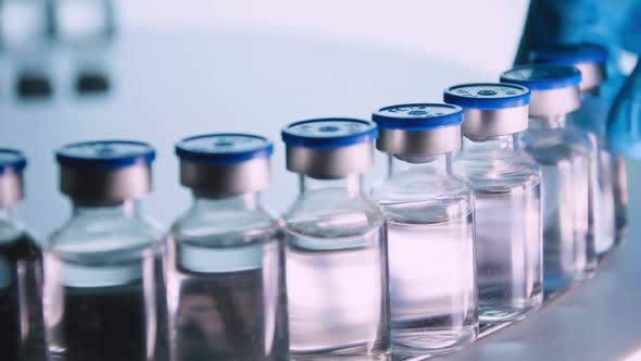 Group of Vaccine bottles. Medicine in ampoules. Glass vials for liquid samples in laboratory. alt