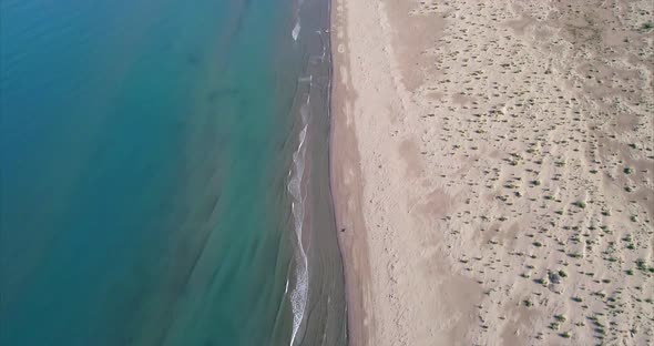 Aerial Tilt Up Shot of a Remote Virgin Sandy Beach on the Adriatic Sea alt