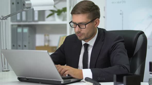 Man in Business Suit Typing on Laptop Pc, Feeling Eye Tension Taking Off Glasses