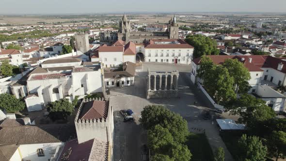 Temple of Diana surrounded by Evora cityscape. Aerial orbiting shot