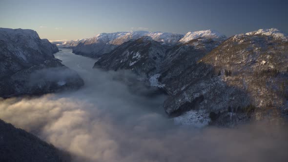 Timelapse with rolling fog and rising sun in beautiful Norwegian fjord alt