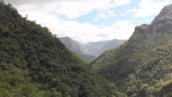 Drone shot of huge green valley with tall mountains in the Amazon of Peru alt