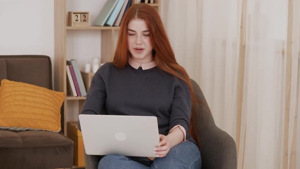 Video chat job interview or distance course with red hair female online teacher. Happy young woman c