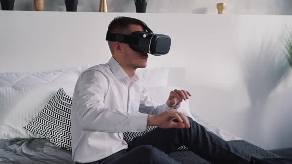 Attractive Man Playing at Games in Virtual Reality Helmet