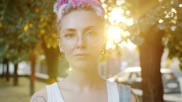 Happy Young Girl with Unique Style Smiling in City Park on Sunny Summer Day alt