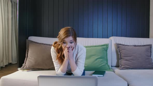 Young Woman Customer Celebrating Winning Bid Or Getting an Ecommerce Shopping Offer On Laptop alt