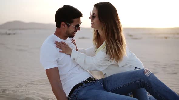 Young Man and Woman Having Fun on Sand in Desert Beautiful Couple Crazy in Love Dune Landscape on alt