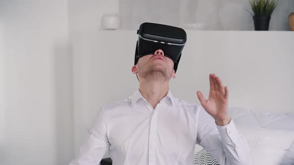 Young Man Looking Up in Virtual Reality Glasses