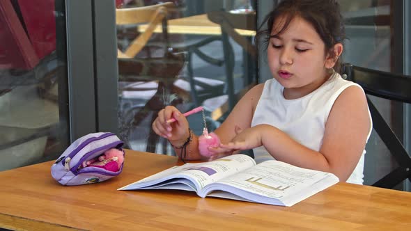 Girl Doing School Homework Outside During Summer Season alt