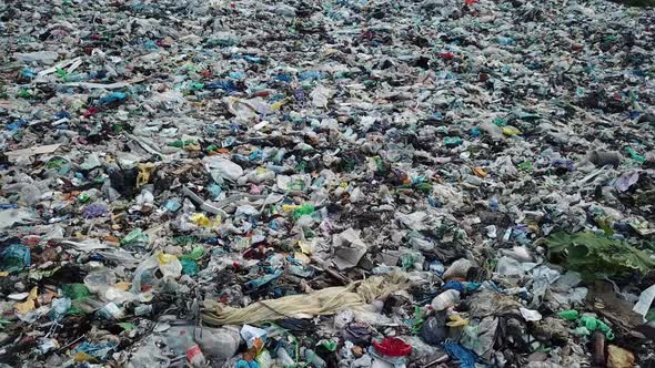 Plastic in the mountains, Mountain garbage, large garbage pile, degraded garbage. alt