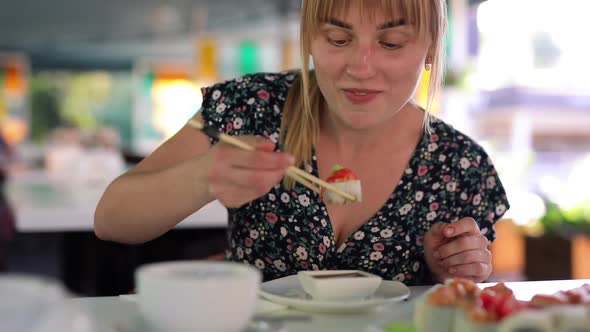 Happy Woman Eating Sushi Rolls
