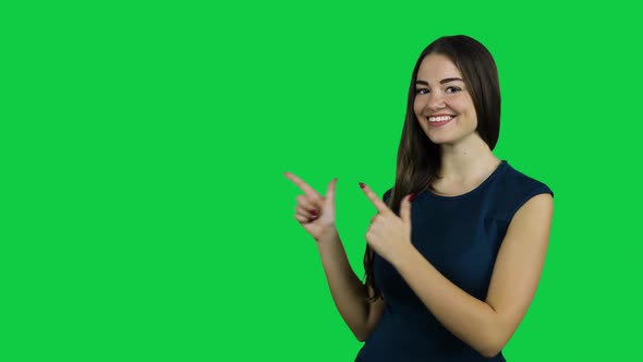 Happy excited girl pointing promoting in front of the green screen alt