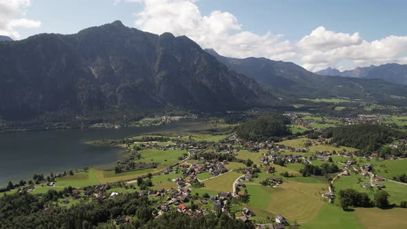 Aerial view of the village, lake, fields and forest in mountains Alps Austria alt