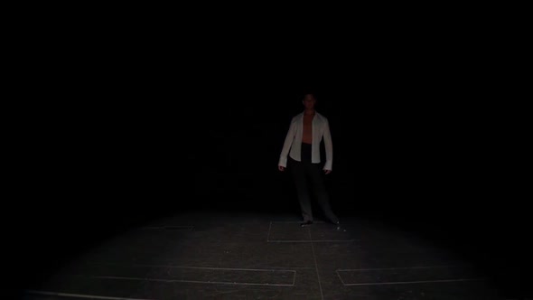 Ballroom Dancer Comes Out of Darkness Onto Marked Stage with Slowflexible Steps Forward and Sideways