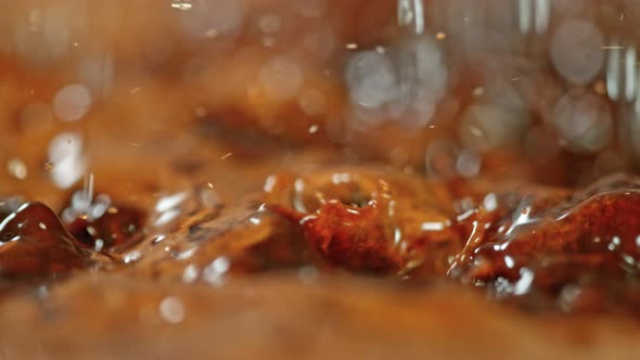 Super Slow Motion Macro Shot of Splashing Fresh Coffee and Water Droplets at 1000 Fps. alt