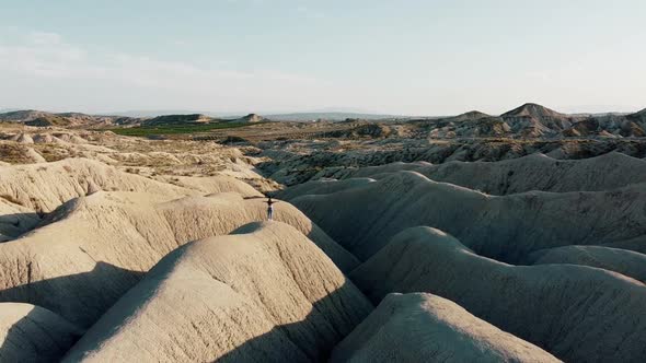 Dunes landscape desert drone point of view of woman with spread arms at Mahoya desert in Spain. alt