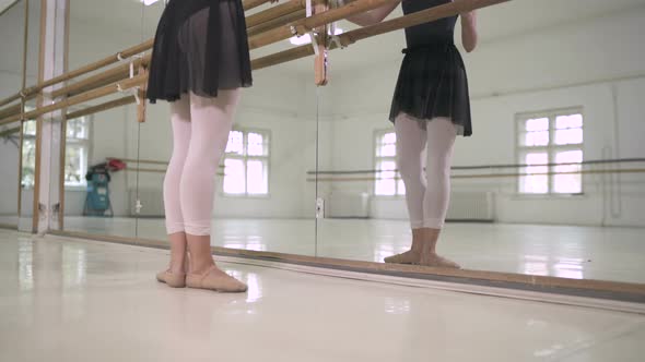 Ballerina stretching her legs alt