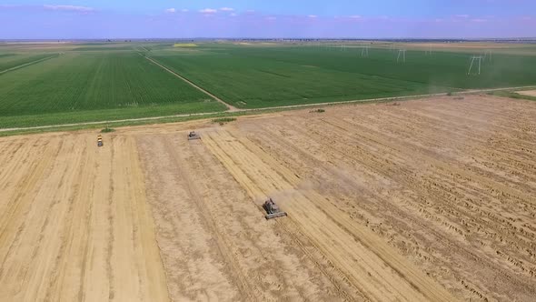 Combine harvesters on field