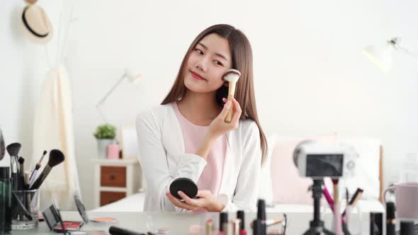 Young beautiful Asian woman professional beauty influencer doing cosmetic live streaming online