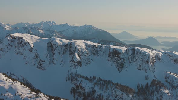 Aerial View From an Airplane of Beautiful Snowy Canadian Mountain Landscape alt