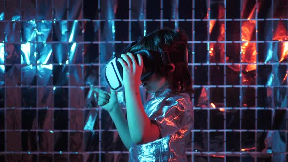 Boy Child in a Silver Shirt and Glasses Virtual Reality Playing a Game alt