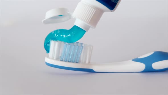 Toothpaste On Toothbrush On White Background