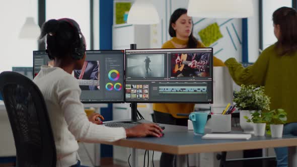 Black Videographer Putting on Headset Editing Movie alt