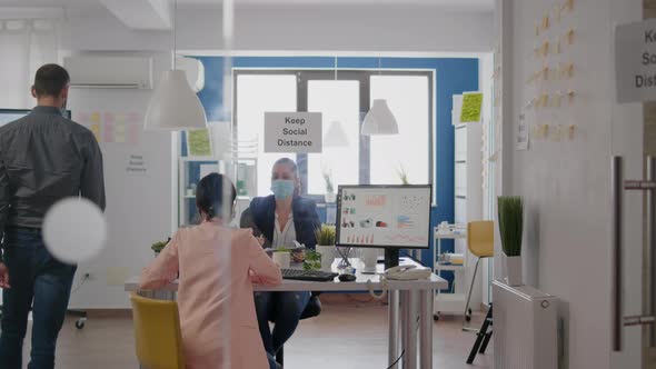 Business Womens with Medical Face Masks Talking About Management Statistics alt