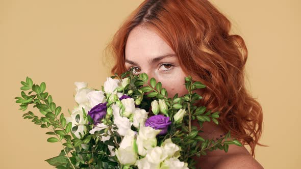 Beautiful Portrait of Sensual Woman 20s with Red Hair Covering Her Face with Bunch of Prairie alt