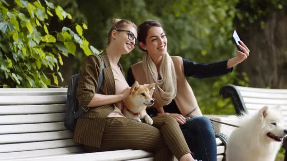 Young Beautiful Women Making Photo in Park alt