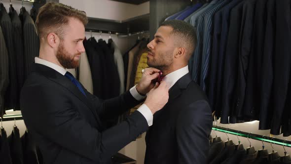 In a Luxury Suit Shop the Consultant Man Carefully