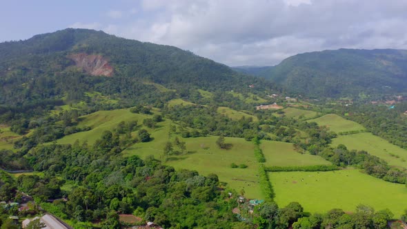Countryside Landscape With Lush Green Fields And Hills In Jarabacoa, Dominican Republic - aerial dro alt