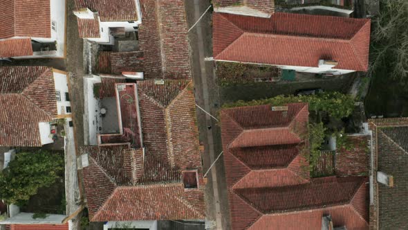 Top View Of White Houses With Red Tiled Roofs In Obidos Village, Portugal - aerial drone shot alt