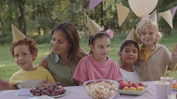 Woman and Kids Posing on Camera alt