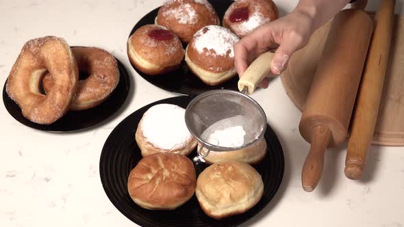 Spreading Sugar Powder On Hanukkah Doughnuts