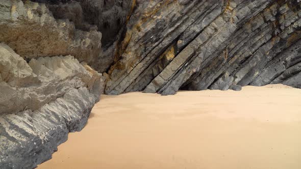 Tectonic Volcaninc Plates in the Beach of Gruta da Adraga in Portugal on Sunny Day alt
