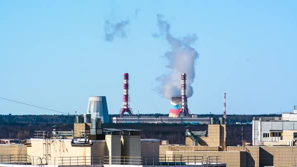 steam from the chimney of the power plant, emissions. switch to electric cars alt