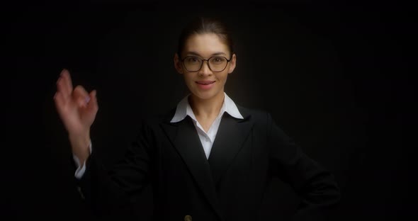 Business Woman in Glasses with a Smile on Her Face Shows Ok Sign