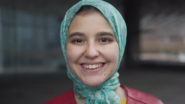 Happy Muslim girl smiling in camera alt