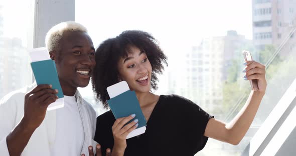 Couple of Teenagers African Man and American Girl Woman Standing Together in Airport Terminal Taking alt