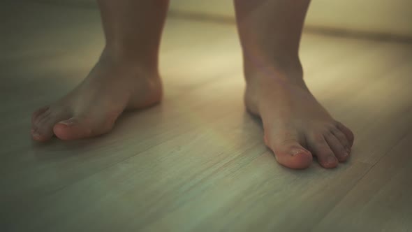 Woman's Legs on Laminate Flooring in Apartment