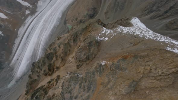 Aerial View Fast Dive From Cliff Peak on Wide Stone Couloir Between Rocks Natural Geology Formation alt