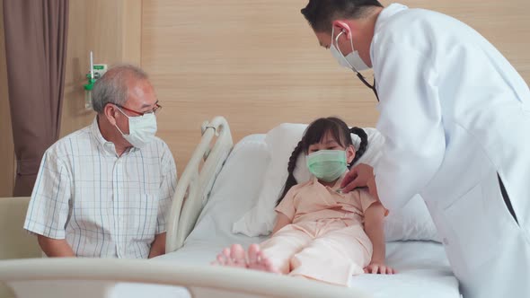 Asian doctor examine measure heart rate by stethoscope on little kid patient on bed in recovery room alt