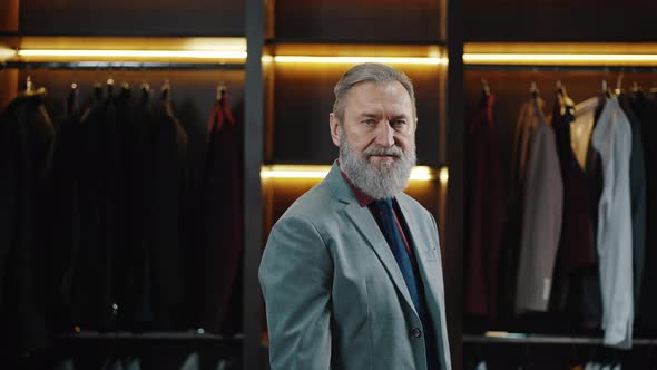 Stylish Confident Rich Mature Businessman Wearing Suit Posing at Own Dressing Room Looking at Camera alt