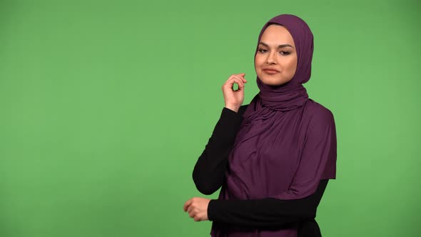 A Young Beautiful Muslim Woman Poses for the Camera  Green Screen Background