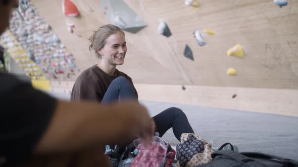 Woman getting ready for a climb at the bouldering gym